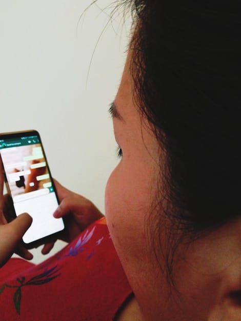 A close-up of a smartphone screen displaying a controversial tweet from a celebrity, with angry comments and reactions visible below.