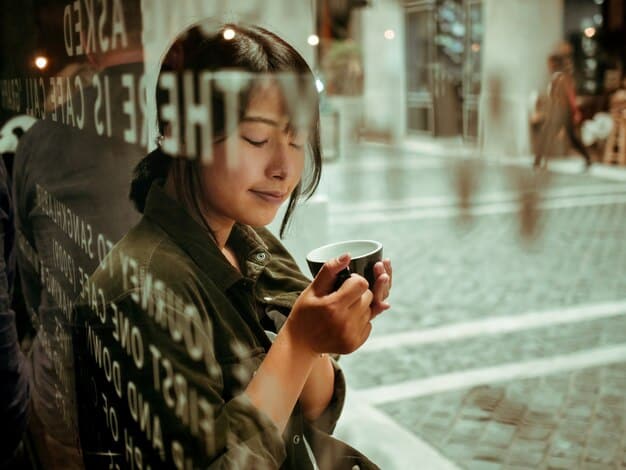 A close-up on a smartphone screen showing a meme with text that can be interpreted as offensive to a minority group. The background is a blurry coffee shop scene.
