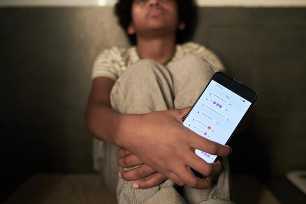 A close-up shot of a smartphone screen displaying a threatening message. The message contains abusive language and an implied threat of violence. The background is blurred to focus on the message.