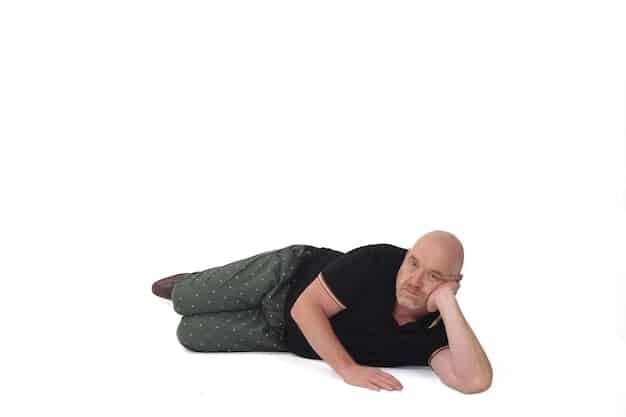 A person is curled up in a fetal position, looking distressed. Their face is partially hidden, and they are surrounded by shadows, conveying feelings of fear, anxiety, and vulnerability. The overall tone is dark and somber.