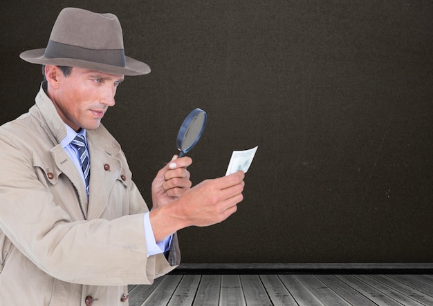 A detective using a magnifying glass to examine a handwritten note that says 