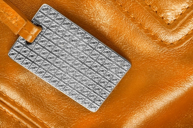 A close-up shot of a serial number and authenticity code on a luxury handbag, with a step-by-step guide on how to verify its authenticity through the brand's official website. This image emphasizes the importance of cross-referencing information during fashion drop authentication.